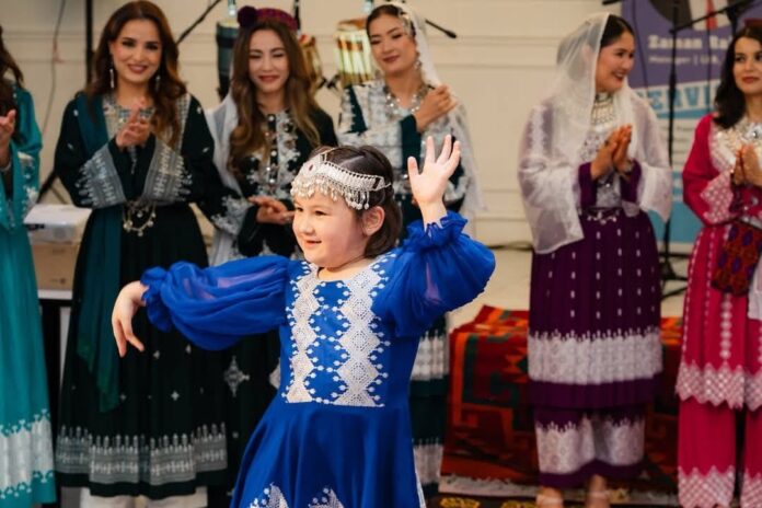 young Hazara girl performs a traditional dance,